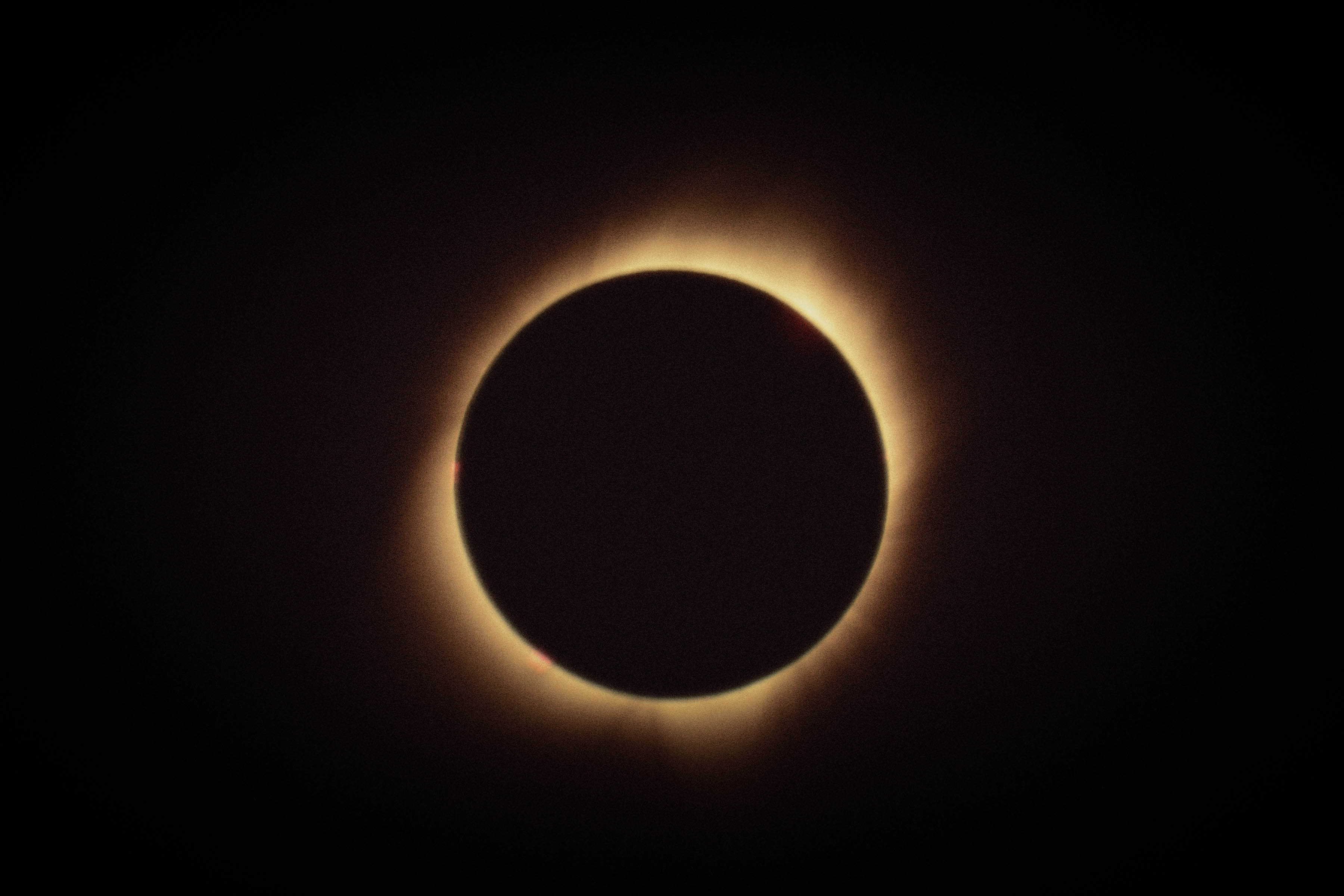 Solar eclipse with golden corona and film grain made with Daydream
